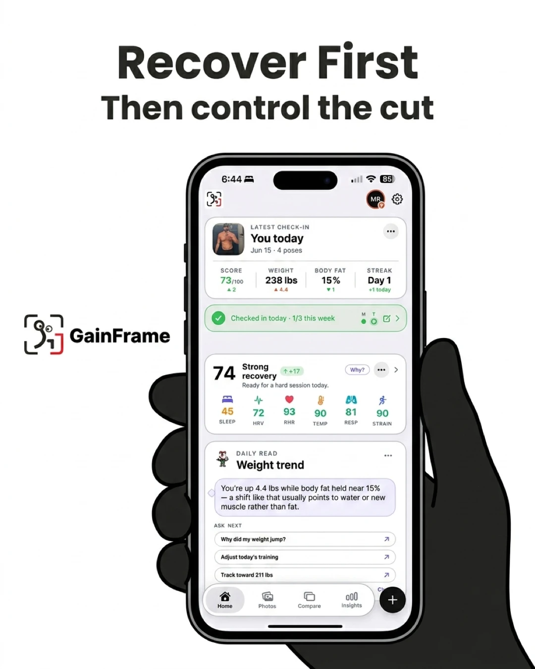 A hand holds a smartphone displaying the GainFrame app interface, which shows recovery metrics and weight trends to emphasize the importance of tracking recovery before focusing on a caloric deficit.