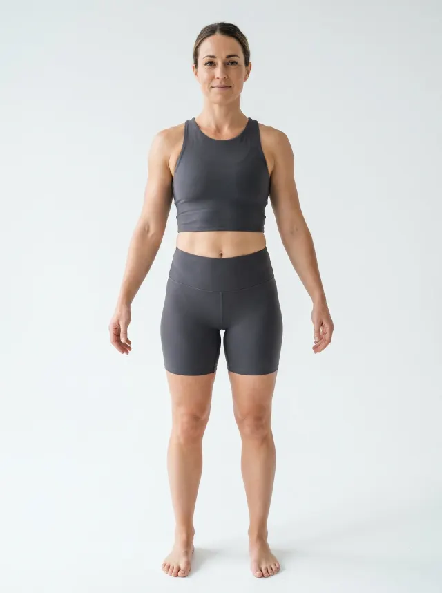 27 percent body fat woman used as a body fat quiz calibration reference with a soft stomach and minimal muscle definition