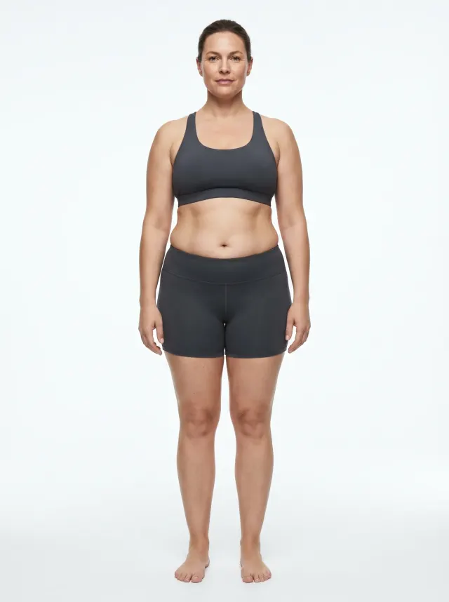 Standardized AI render of a woman at 32 percent body fat, average build with softness at the hips and lower belly